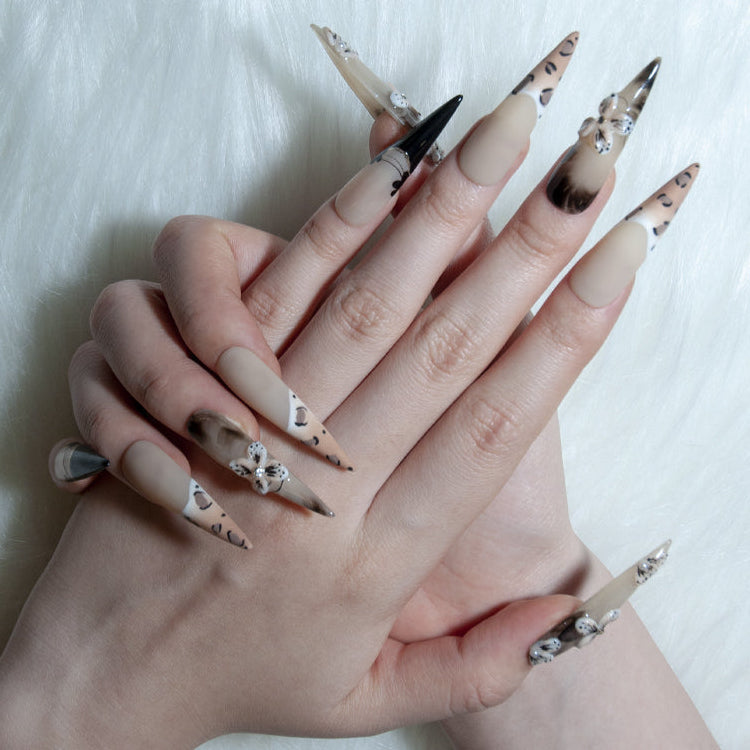 Luxury wild style nails with nude and leopard print design, rhinestones, and 3D flowers