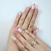  Handmade almond nails featuring 3D blossoms, red tips and silver glitter details