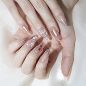 Elegant press-on nails with delicate blossoms and rhinestone accents
