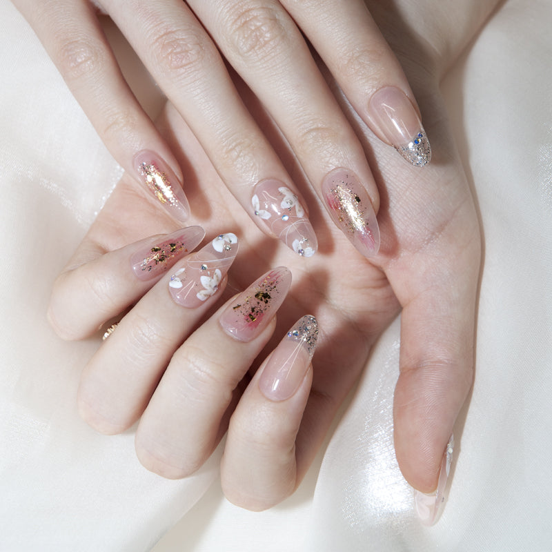 Elegant press-on nails with delicate blossoms and rhinestone accents
