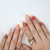 Colorful press-on nails with tropical fruit motifs, glossy finish and playful details