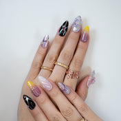 Mixed design press-on nails featuring black contrast, ombré, and 3D petals