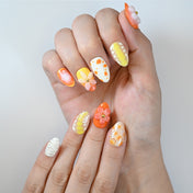 Tropical summer nails featuring 3D blossoms, yellow gradient, orange spots and glossy shine
