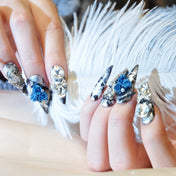 Handmade dramatic nail art with lace, pearls, and oversized crystals in black and silver