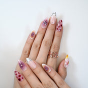  Luxury animal print nails with burgundy pattern, zebra tip accent, and floral embellishment