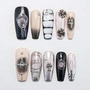 Black and nude press-on nails with silver metallic accents and 3D cross charms