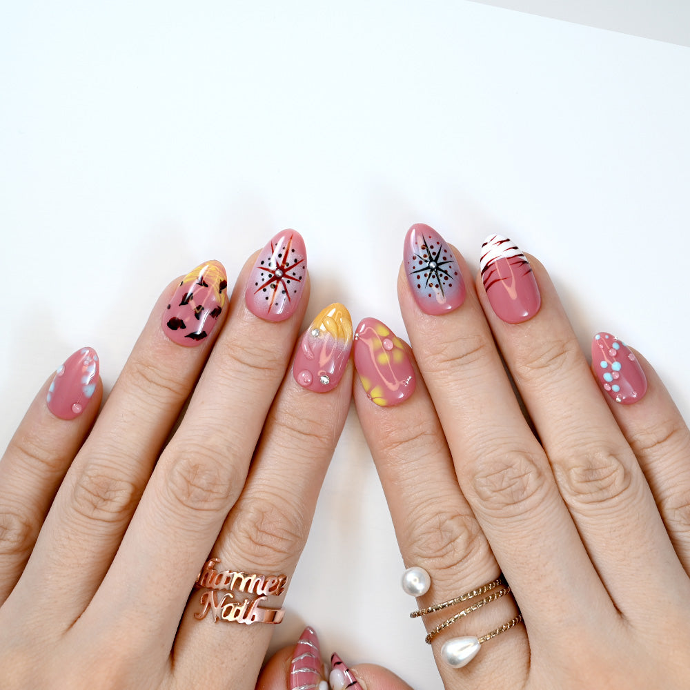 Bold press-on nails with firework-inspired designs, candy stripe tips and glossy finish