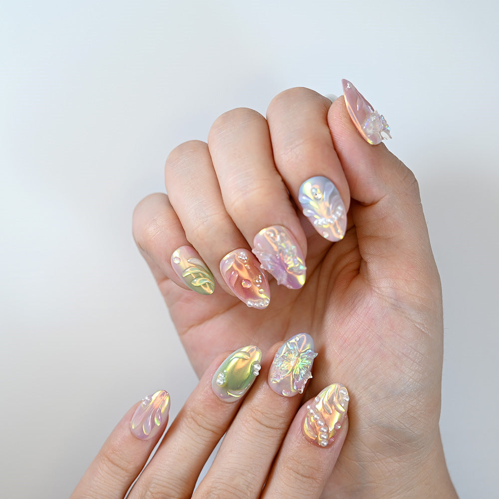  Holographic gradient nails featuring seashell patterns and gemstone details