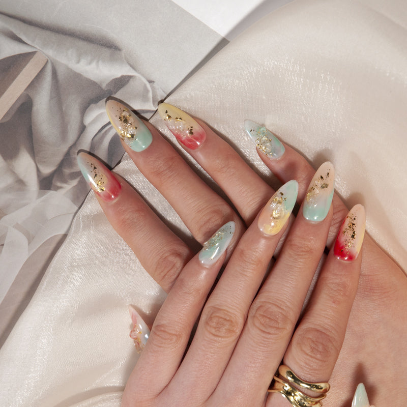 Handmade almond nails in watercolor ombre with crystal stone and gold flakes