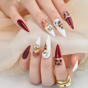 Handmade luxury nails featuring animal print, deep wine red, and crystal rhinestones