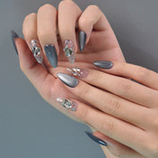 Elegant party nails featuring grey cat-eye effect with 3D silver foil inlay