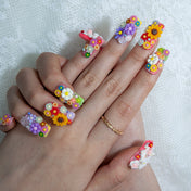 Colorful kawaii nails with 3D flowers, pastel accents, and sunflower art
