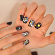 Black glitter press-on toenails with celestial and beach elements