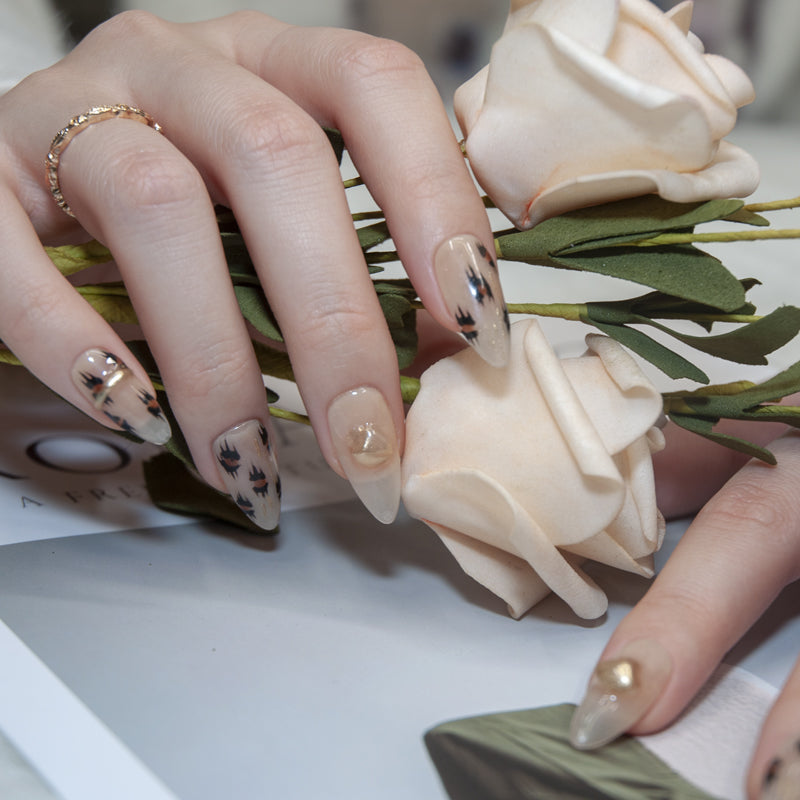 Chic leopard print press-on nails with nude base and metallic gold details