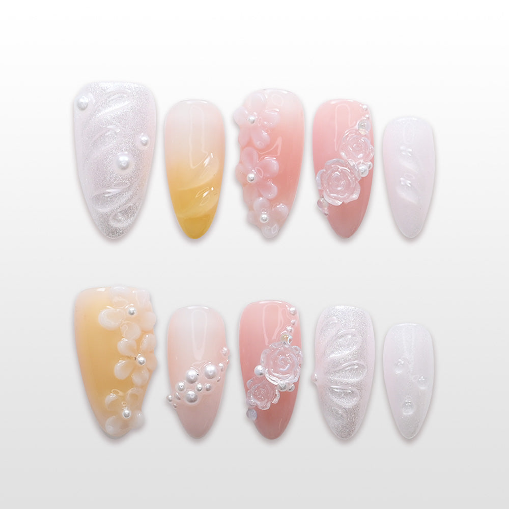 Pastel pink and yellow ombre press-on nails with 3D flowers and pearls"