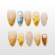 Yellow floral press-on nails with pearls and hand-painted flower accents