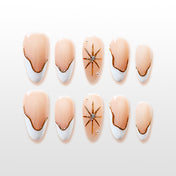 Nude and white French tip press-on nails with gold wavy lines and crystal star design