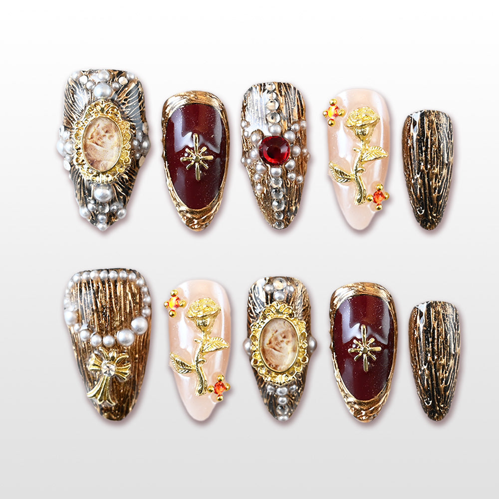 Vintage royal style press-on nails with gold frames, pearls, and gemstone accents