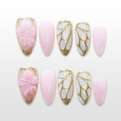 Pink and gold press-on nails with 3D cherry blossom design and glitter gradient