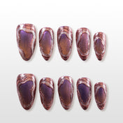 Metallic copper and purple press-on nails with abstract swirl texture and glossy finish