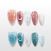 Rose gold press-on nails with 3D swirl roses, glitter, and gemstone accents