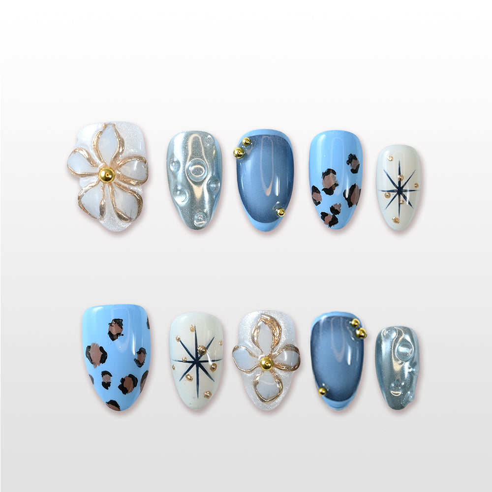 Trendy animal print press-on nails in blue and white with 3D gold floral design