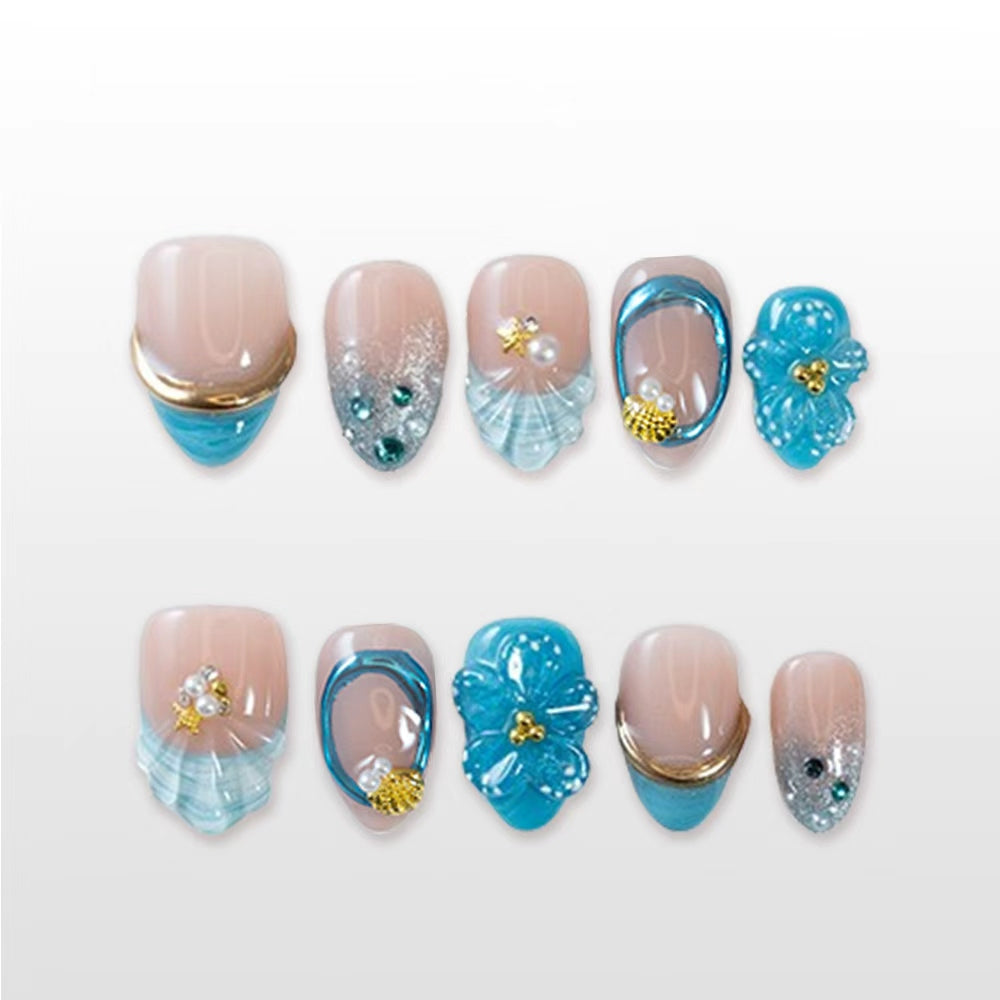 Set of ocean blue press-on nails with seashell texture and 3D tropical flowers"