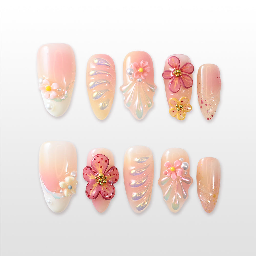 Peach and pink floral press-on nails with 3D flowers, pearls, and iridescent accents