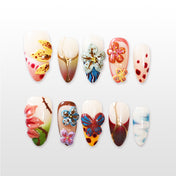 Colorful 3D flower and butterfly press-on nails with hand-painted patterns and gold accents