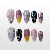 Black and silver press-on nails with gemstone accents and purple shimmer