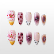 Handmade glossy almond nails in wine red, nude, and gold with floral and animal print details