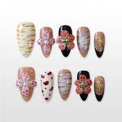 Handmade glossy nails featuring red floral charms, heart patterns, and elegant black tips