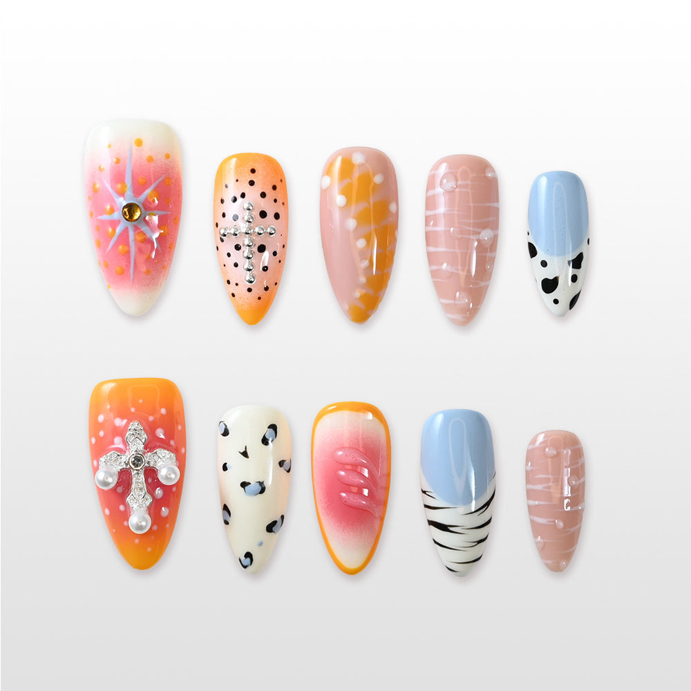 Handmade nails featuring orange ombré, blue accents and black leopard spots