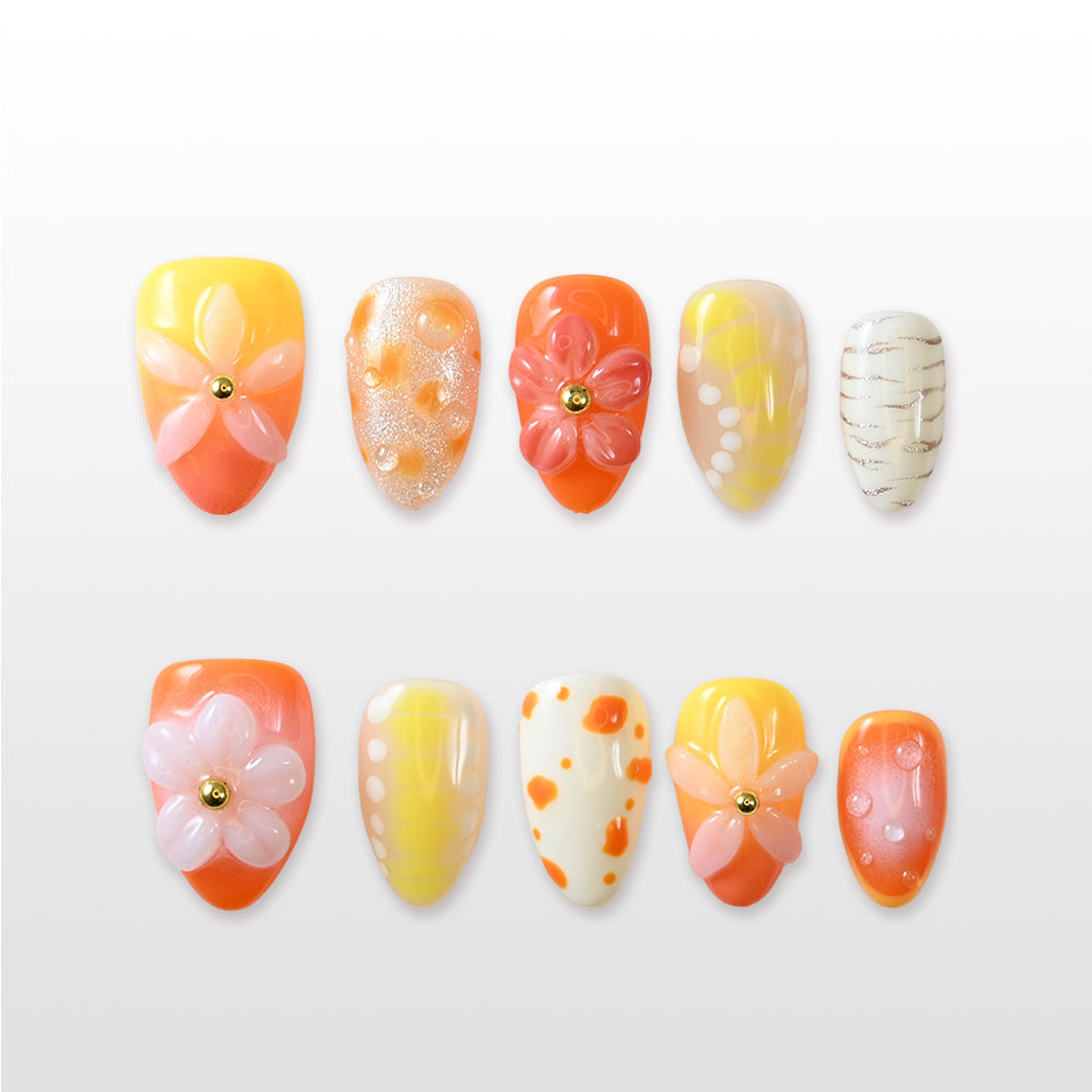 Handmade glossy nails featuring tangerine tones, textured glitter, and pastel floral designs