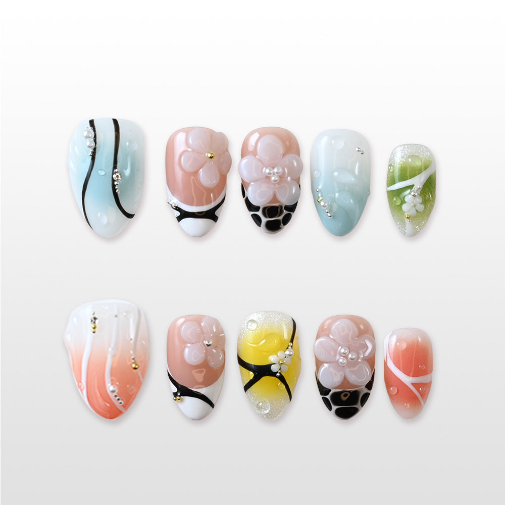Spring summer press-on nails with pastel ombre, cute flowers and gold detail