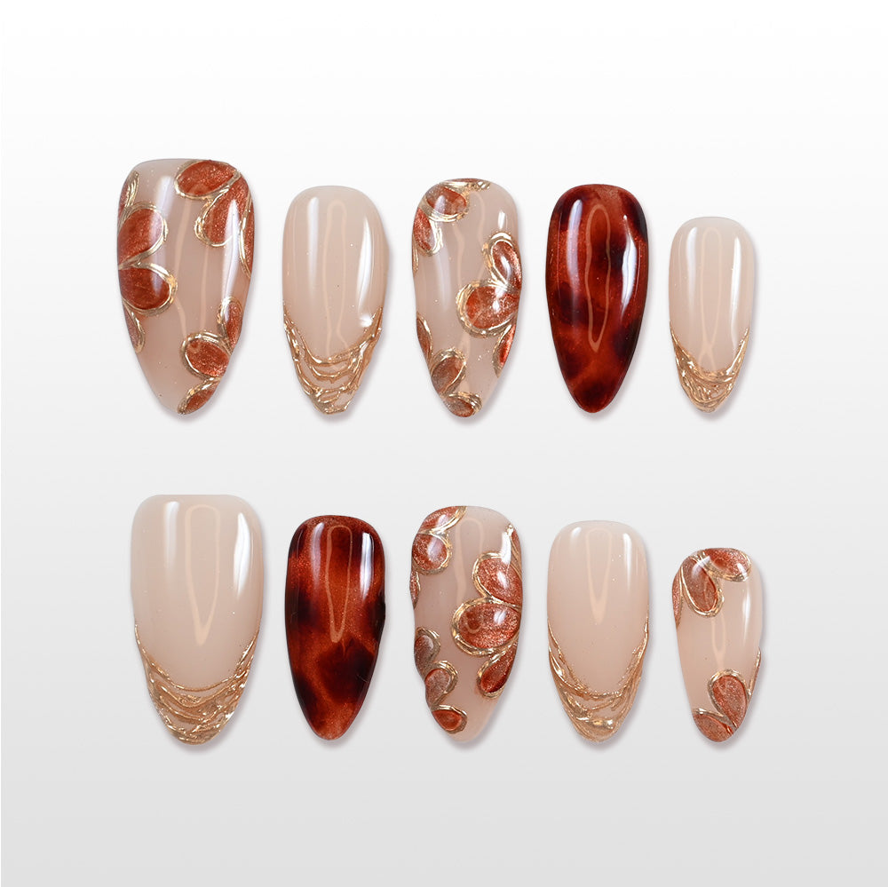 Handmade fall-inspired press on nails in amber tones and soft nude base