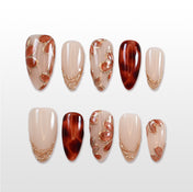 Handmade fall-inspired press on nails in amber tones and soft nude base