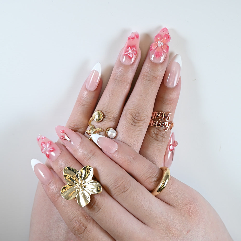 Natural nude nails with soft pink flower embellishments and glossy French manicure