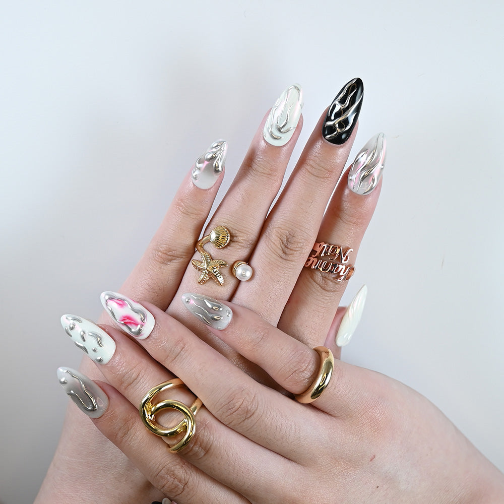 High contrast almond-shaped press on nails with futuristic silver art and pearl rings