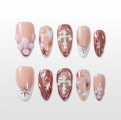 Reusable press on nails with sculpted rose gold texture and delicate floral and pearl elements