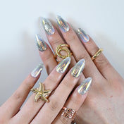 Glossy silver almond shaped nails with futuristic 3D shine and minimal embellishments