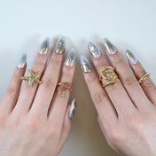 Galaxy themed press on nails in silver chrome with celestial patterns and 3D accents