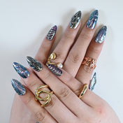 Full hand photo wearing holographic chrome press on nails with 3D texture and art rings