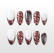 “Handcrafted rose gold swirl nails with almond shape and futuristic shine”