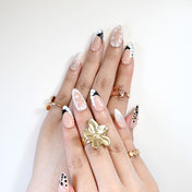 Handmade nude and black abstract nails with bubble texture and metallic foil