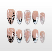 Nude press-on nails with black polka dots, bubble art, and silver foil accents