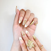 Luxury Christian style nails with gold crosses, 3D metallic details, and glossy finish