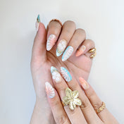 Handmade almond nails with iridescent seashell texture and pink-blue ombre