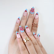 Reusable press-on nails with pastel pink, sky blue, and 3D embellishments