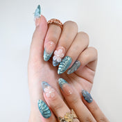 Blue shimmer ocean press-on nails with floral design